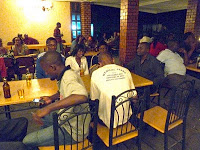 Customers drinking and eating at tables at the Kalahari Lodge, Lusaka (c) Melissa Shales